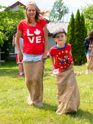 mother and son in a potato sack race wearing red