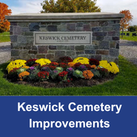 Stone entrance feature with yellow, red and orange flowers in front says Keswick Cemetery with blue box at the bottom stating Keswick Cemetery Improvements