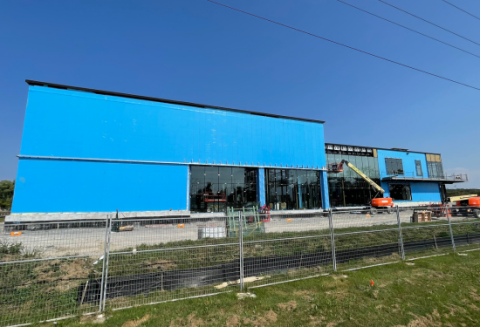 Building under construction with blue siding and windows