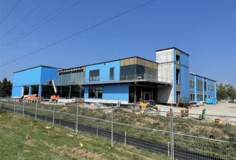 Building under construction with blue siding and windows