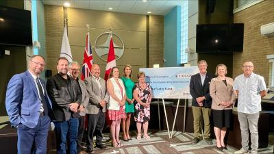 Mayor, members of Council, staff and provincial dignitaries at housing cheque presentation