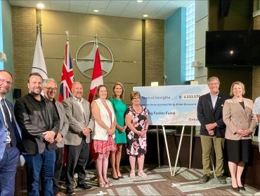 Mayor, members of Council, staff and provincial dignitaries at housing cheque presentation